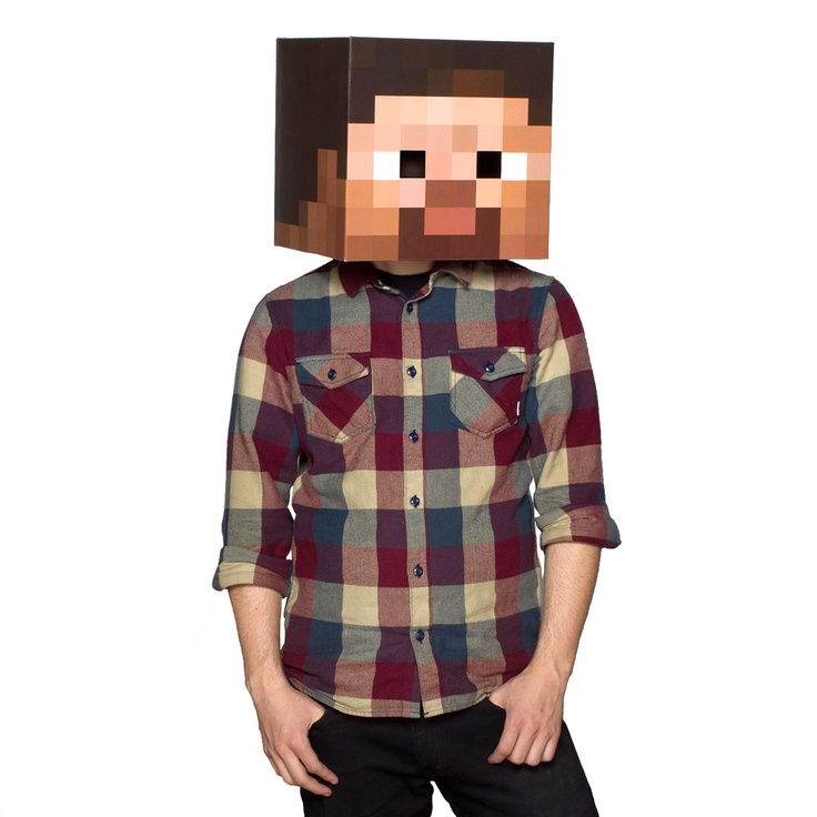 a young man wearing a paper head made to look like a minecraft creeper