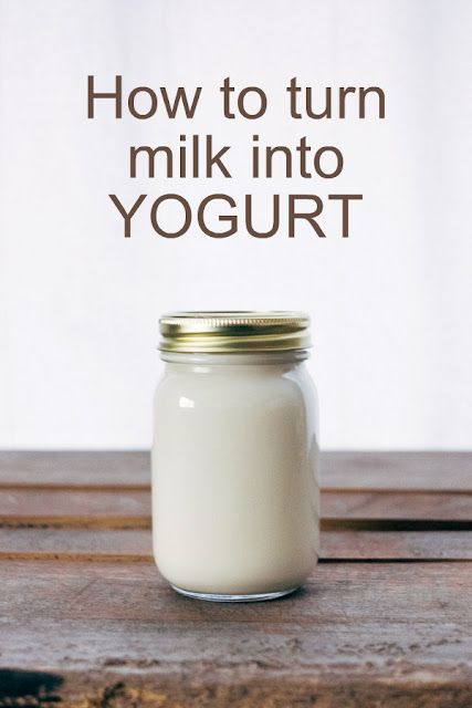 a glass jar filled with milk sitting on top of a wooden table