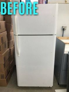 a white refrigerator freezer sitting inside of a kitchen next to boxes and cardboards