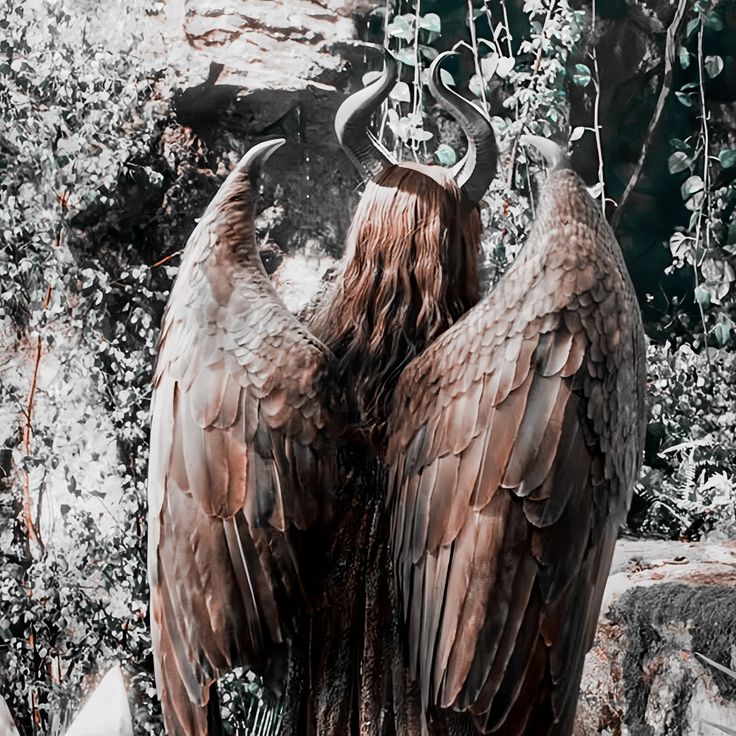 two large brown birds with horns standing next to each other