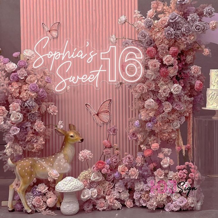 a pink backdrop with flowers and a deer in front of it that says, sophia's sweet 16