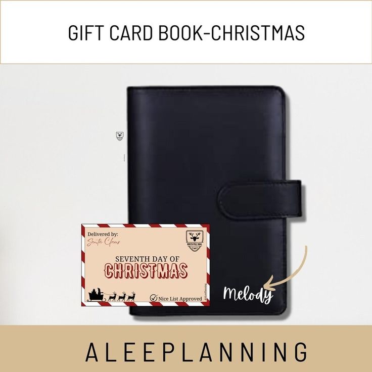 a gift card book with a christmas message on it and a black leather wallet next to it