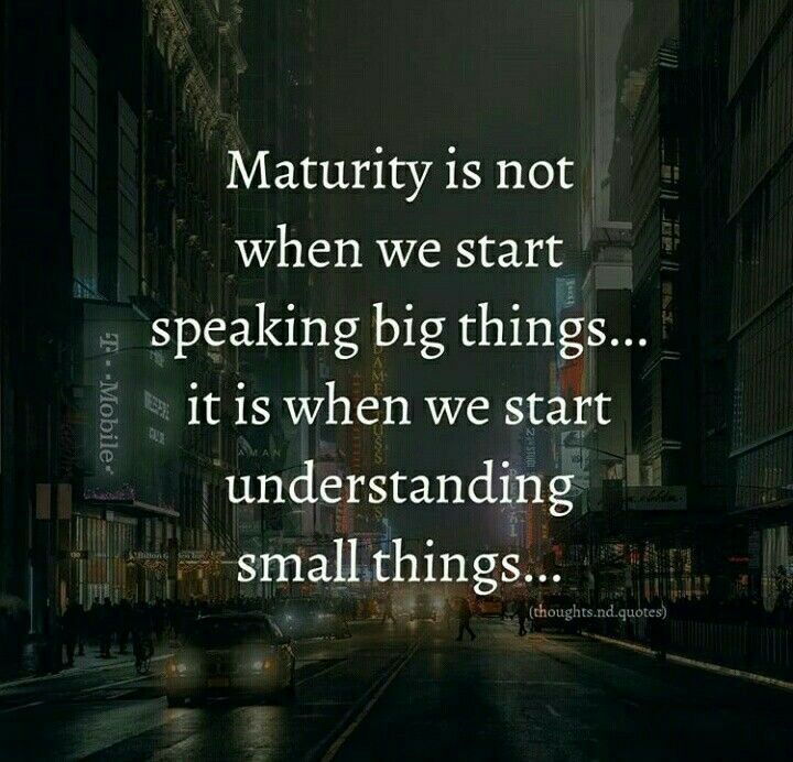 a city street at night with the words,'maturify is not when we start speaking big things it is when we start understanding small things