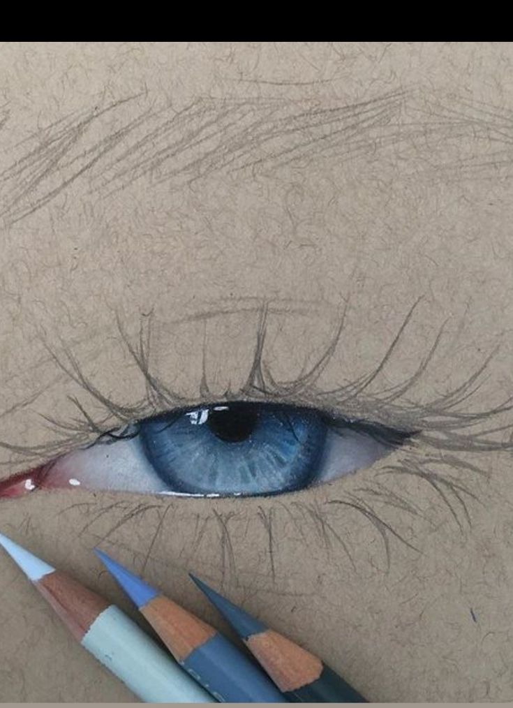 a pencil drawing of an eye with blue eyes