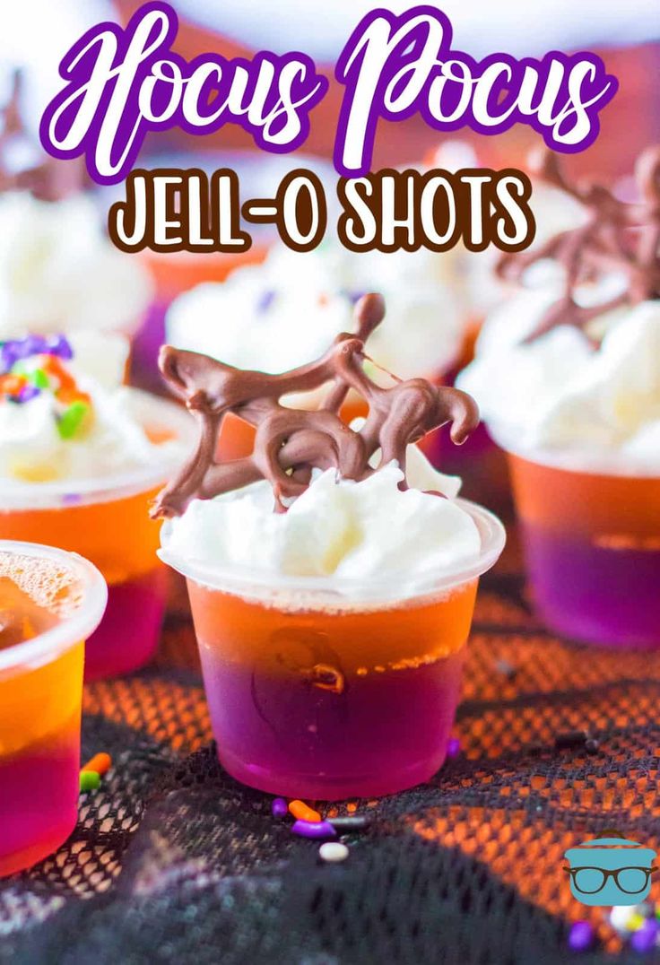 jello shots with frosting and sprinkles on the top are sitting on a table