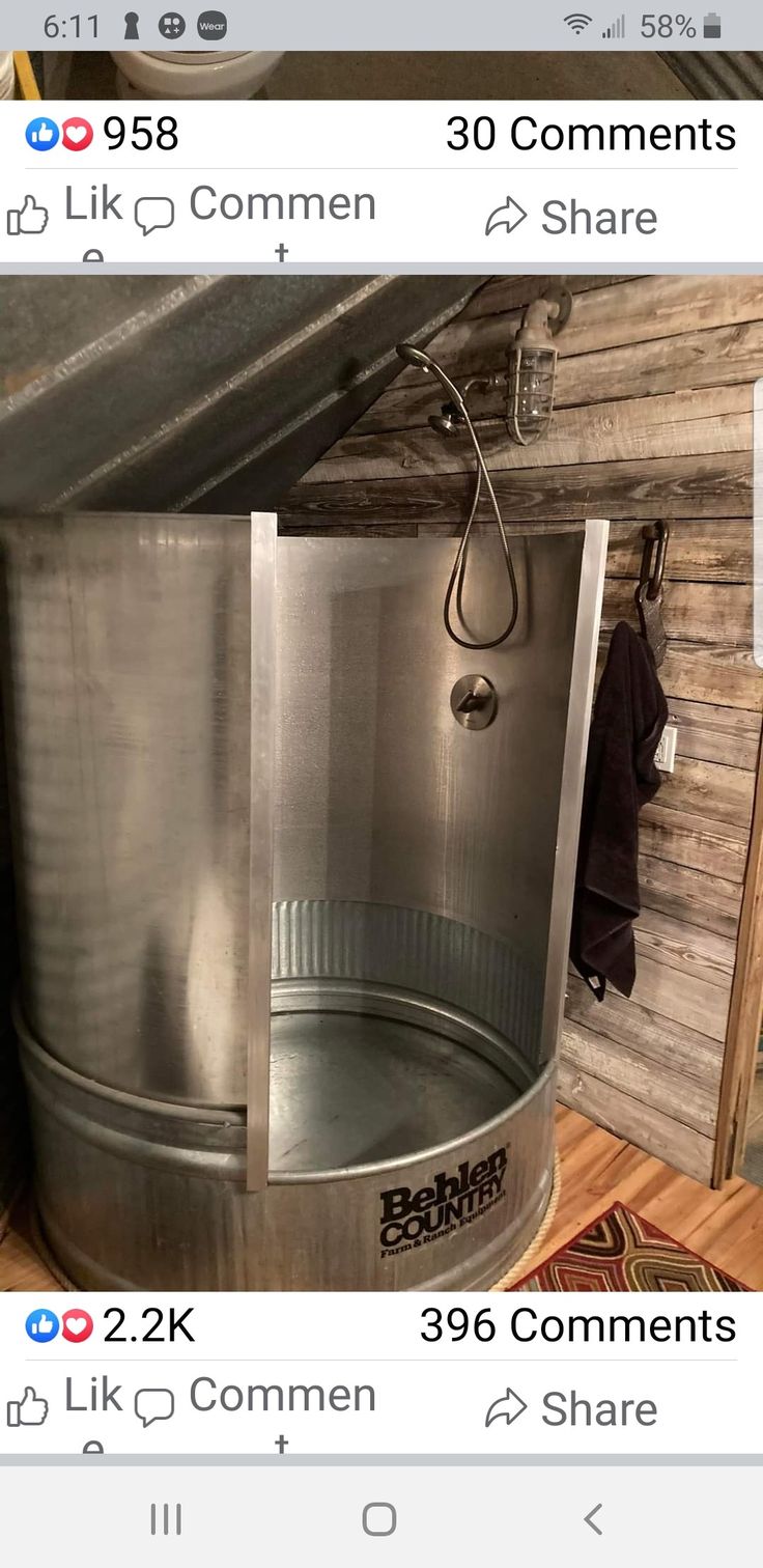 a large stainless steel shower in the corner of a room with wood walls and flooring