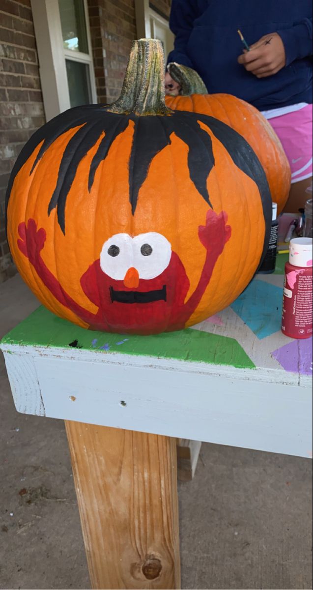 a large pumpkin with an evil face painted on it