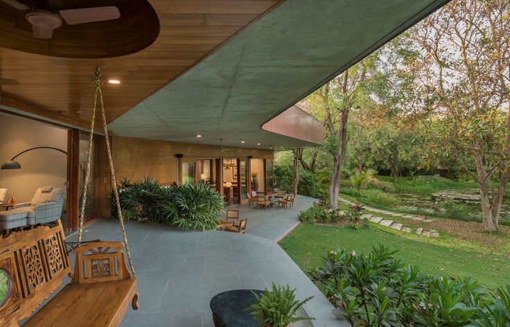 an outdoor living area with swings and chairs