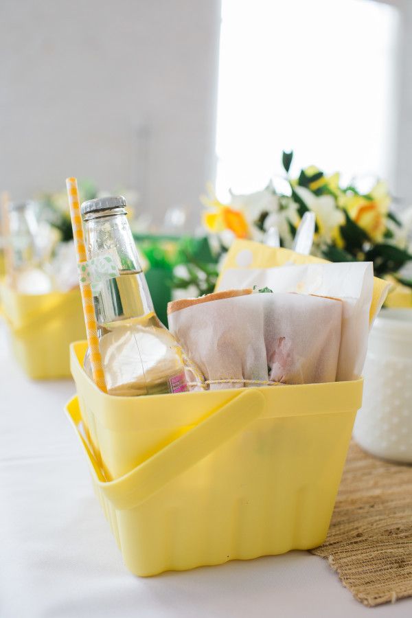 there are three yellow containers with drinks in them on the table next to other food items