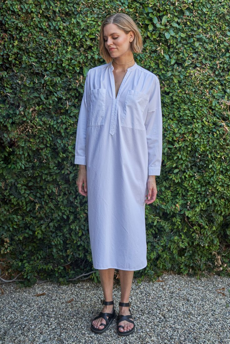 Eco friendly caftans and tunics inspired by the ocean, made on main street. Ethically sourced and locally made in Los Angeles. Inspired by French-girl chic and summers on the Cote d'Azur, meet our new favorite dress. Part shirt, part dress, part mens-wear inspired tunic, we love the oversized pockets, delicate pleats at the shoulder and generous cut. Like the majority of our dresses, this one has functional pockets, too. The cotton poplin is super soft and packs like a dream. With a shirt tail hem, pair this one with sandals or sneakers for elevated lounging or perusing your favorite market (whether its your local grocer or far away exotic bazaar). INSIDER TIP: This one is cut VERY roomy so please check the sizing tab for the best fit. Sheerness: noneFabric: 100% CottonMachine wash, hang, Spring Casual Unlined Kaftan, Spring Daywear Long Sleeve Kaftan, Elegant Spring Kaftan With Relaxed Fit, Chic Daywear Kaftan For Spring, Elegant Summer Kaftan For Daywear, Elegant Kaftan For Summer Daywear, Relaxed Fit Unlined Dresses For Loungewear, Relaxed Fit Lounge Dress, Summer Tunic Shirt Dress With Relaxed Fit