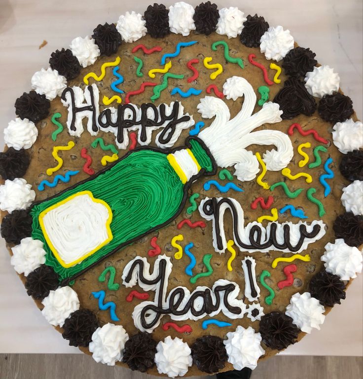 a birthday cake decorated with the message happy new year and an image of a bottle