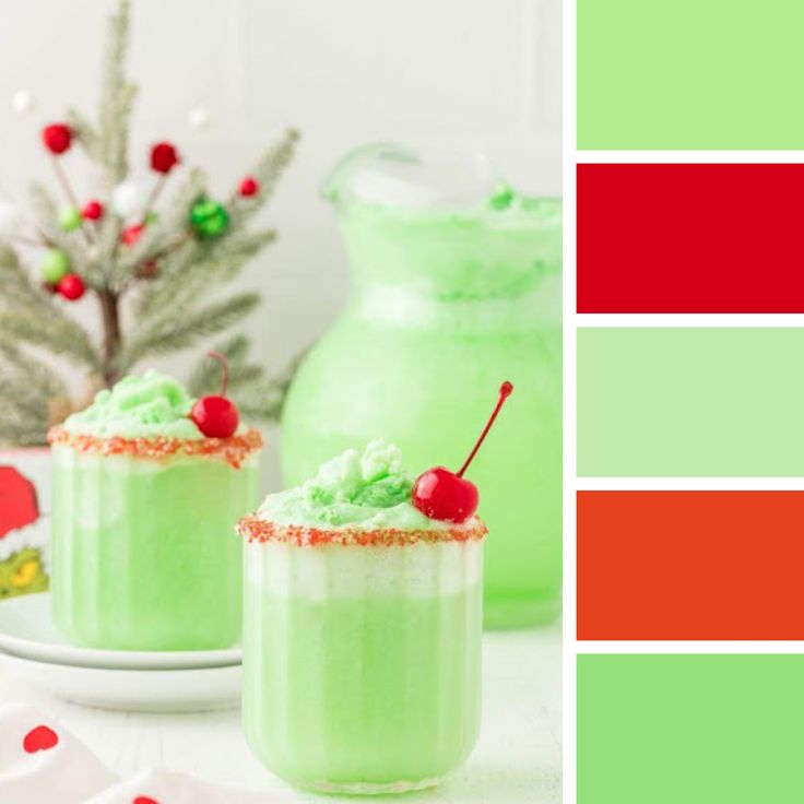 two glasses filled with green and red drink on top of a table next to a christmas tree