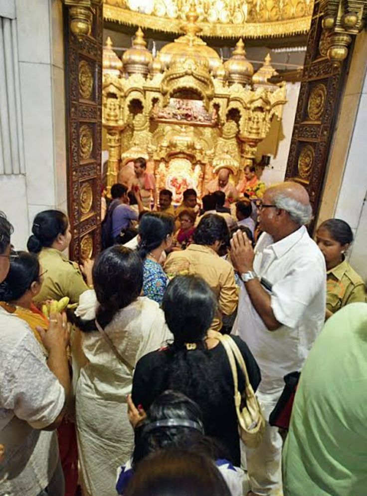 a group of people standing in front of a shrine