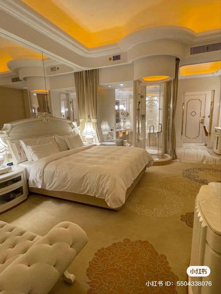 a large white bed sitting inside of a bedroom