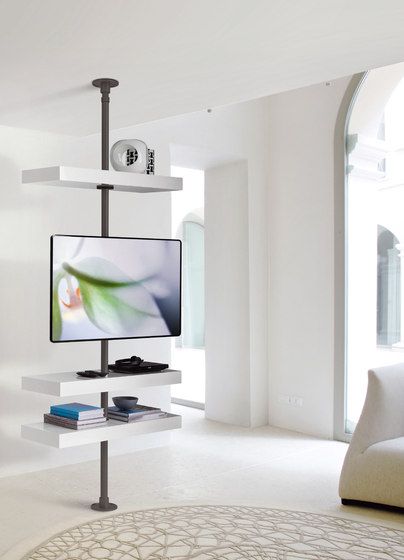 a flat screen tv sitting on top of a white shelf