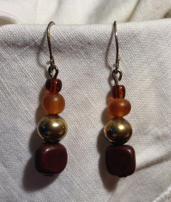 These earrings are beautiful!!  They are golden glass beads with antique silver and brown wood beads hanging from ear wires. Vintage Brown Beaded Earrings For Gift, Vintage Brown Beaded Earrings As Gift, Vintage Brown Round Bead Earrings, Brown Nickel-free Dangle Beaded Earrings, Vintage Brown Beaded Dangle Earrings, Vintage Brown Beaded Earrings, Nickel-free Brown Beaded Dangle Earrings, Brown Copper Bead Earrings, Brown Copper Beaded Dangling Earrings