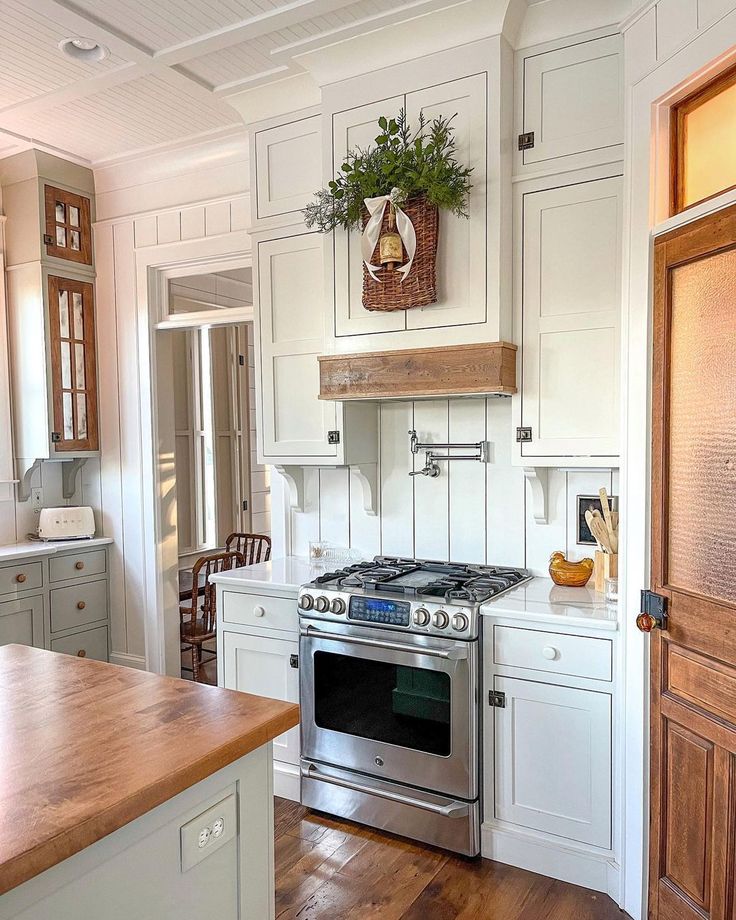 a kitchen with an oven, stove and wooden counter tops in the middle of it