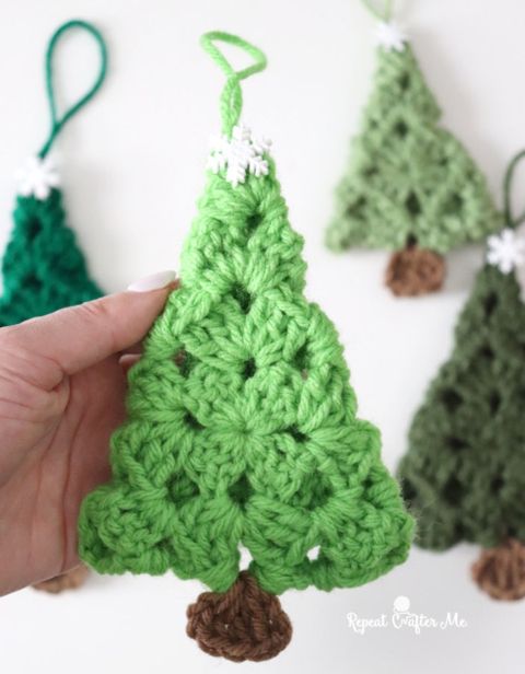 crochet christmas tree ornament being held up by someone's hand