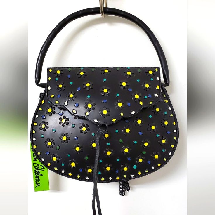 New With Tags So Cute And Unique!! Bag Is Made Of Black Iron With Whimsical Yellow Raised/Textured Daisy Embellishments Despite Being Metal, It Isn't Heavy Carry By Its Handle Or The Metal Chain Shoulderstrap (Approx 24" Drop) * Plain But Roomy, Lined Interior * Darling, Unique Purse! Measures: 9"X7"X2" Evening Yellow Satchel With Top Carry Handle, Yellow Evening Satchel With Top Carry Handle, Yellow Evening Bags With Handles, Yellow Top Handle Satchel With Mobile Phone Bag, Yellow Satchel With Adjustable Strap For Evening, Yellow Shoulder Satchel For Evening, Yellow Pouch Satchel With Detachable Strap, Yellow Tote Satchel With Mobile Phone Bag, Yellow Pouch Shoulder Bag For Evening