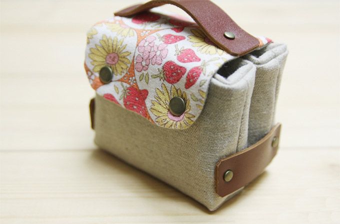 a small purse sitting on top of a wooden table