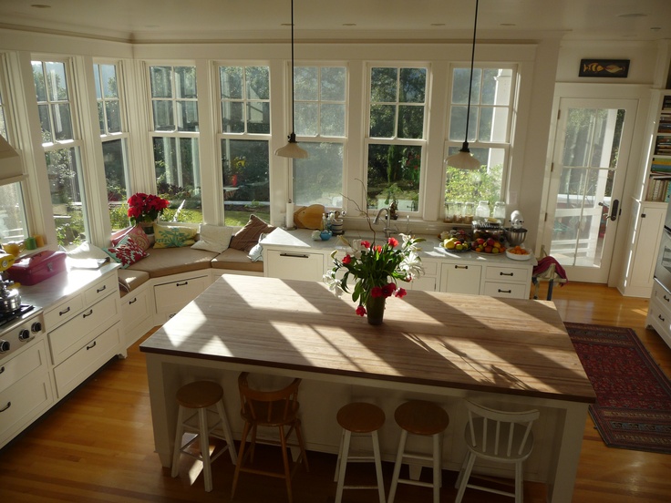 the sun shines through the windows in this kitchen