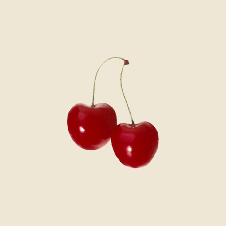 two cherries hanging from the side of each other