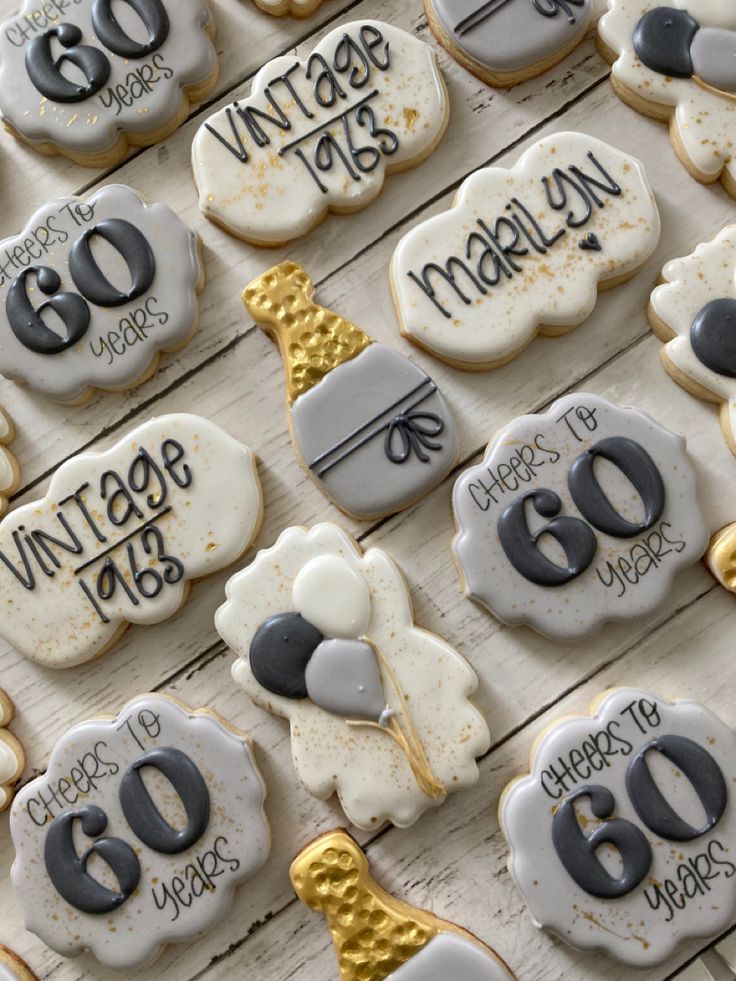 decorated cookies are displayed on a table for 60th birthdays and anniversary celebrations to celebrate