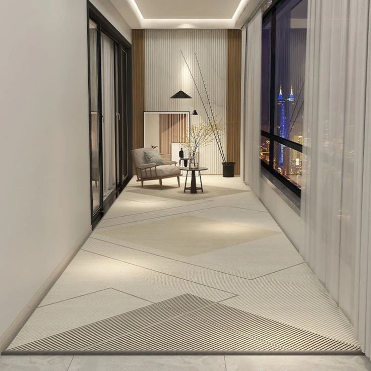 an empty hallway leading to a living room with a view of the city at night