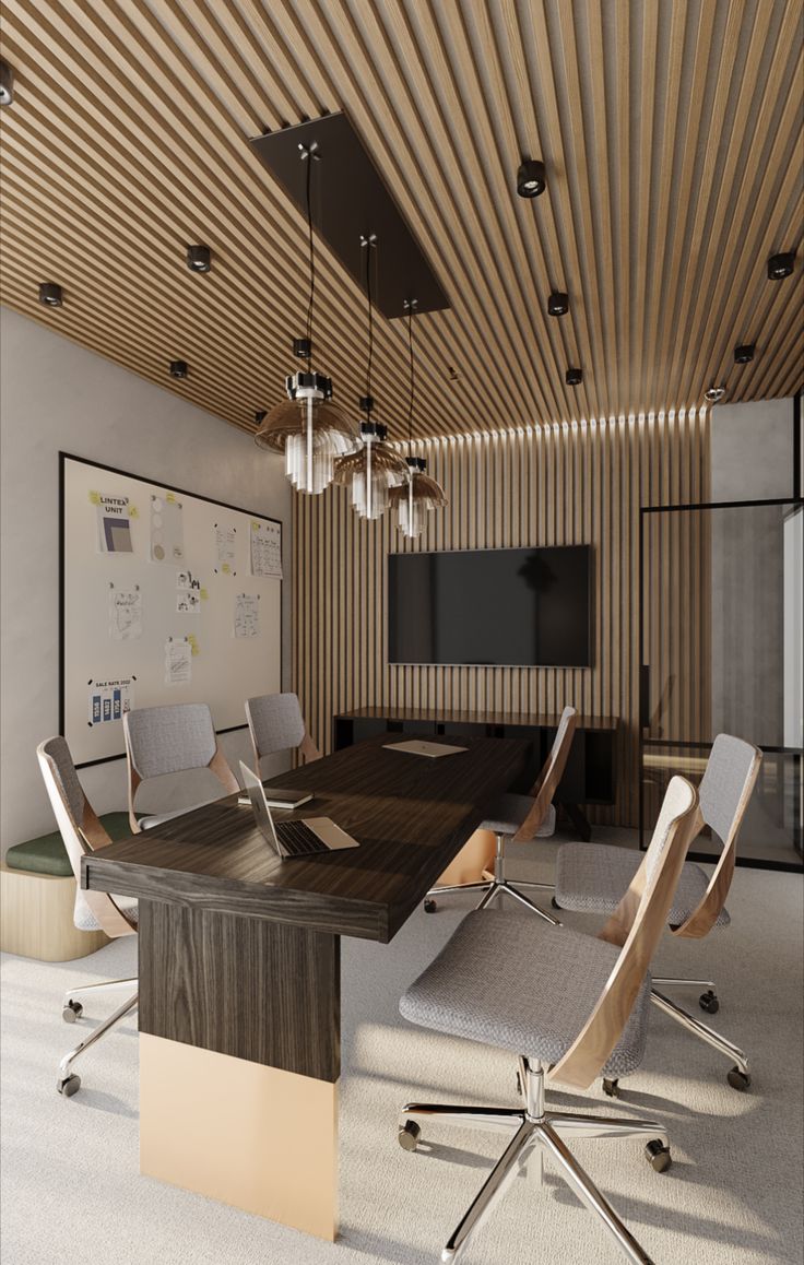 an empty conference room with chairs and a large board on the wall in front of it