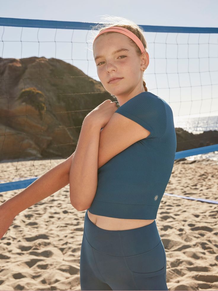 FOR: School, practice, and play FEEL: Non-chafing, ribbed seamless fabric is stretchy and comfortable FAVE: Double layered fabric for added coverage Close to the body for live-in comfort Cropped length hits just above the waist Body length in size medium: Regular: 14". Seamless 4-way Stretch Sportswear Tops, Fitted Summer Training Top, Fitted Tops For Training In Summer, Fitted Tops For Summer Training, Seamless Compression Tops For Summer, Summer Compressive Breathable Tops, Compressive Breathable Summer Tops, Summer Breathable Compressive Tops, Blue 4-way Stretch Top With Seamless Construction