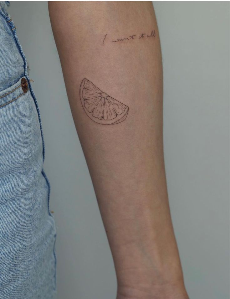 a woman's arm with a small tattoo on it