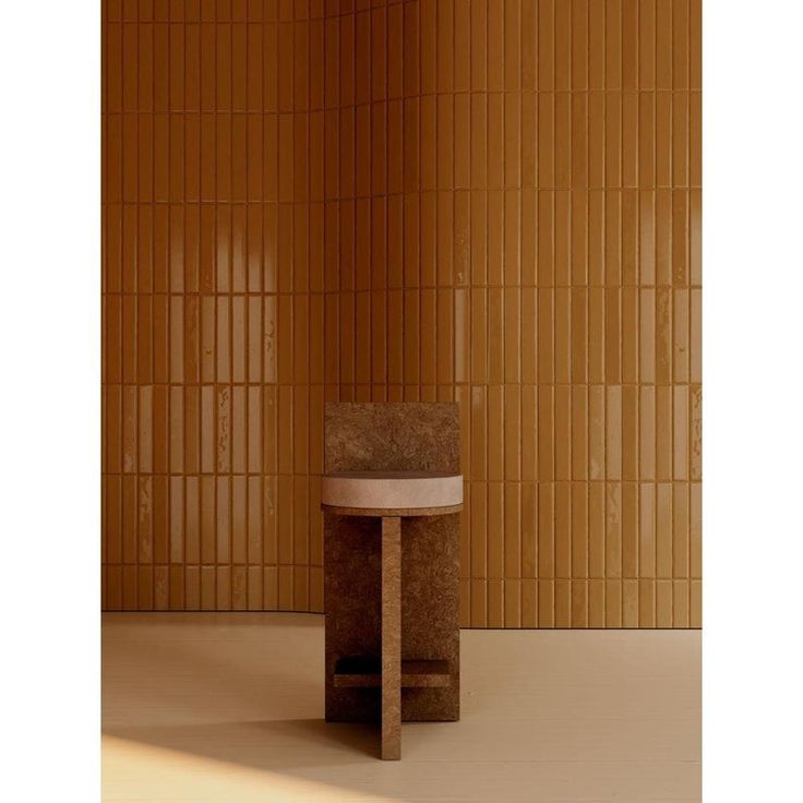 a small round table sitting in front of a wall with bamboo panels on it's sides