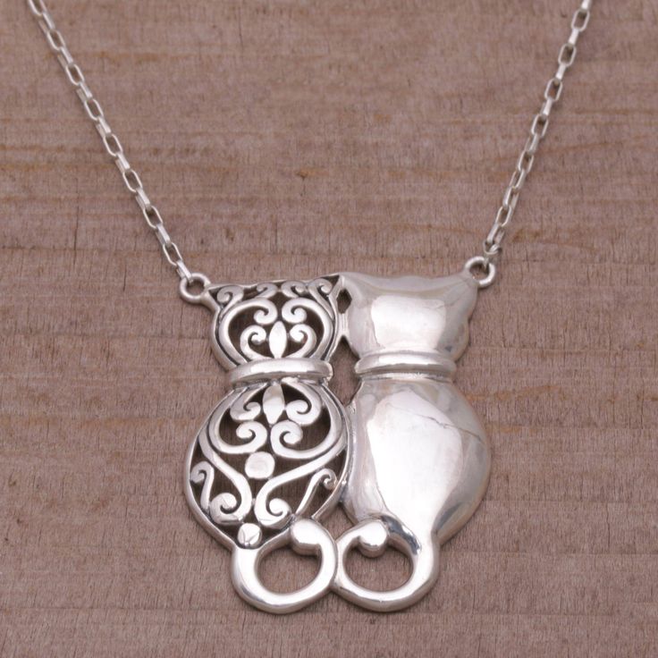 Sitting side-by-side two kittens express their love for each other in the pendant of this Balinese necklace. Janice Girardi designs the necklace crafting it of sterling silver. She elaborates the pendant with spiral motifs and a combination of finishes to distinguish the two cats. All profits from each purchase of Janice Girardi Designs for BAWA sterling silver jewelry will provide life-saving medical services and vaccines for local animals. Cheap Metal Necklace With Cat Design, Bali Romantic, Necklaces Grunge, Silver Earrings Outfit, Silver Cat Pendant, Two Kittens, Unique Silver Rings, Pretty Jewelry Necklaces, Cat Pendant Necklace