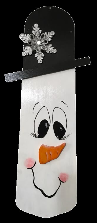 a paper bag with a snowman's face painted on it and a black hat