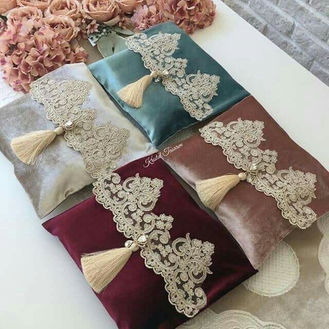 four different colored pillows with tassels on them