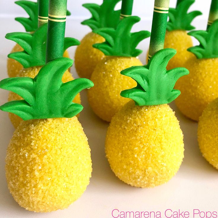 small pineapple cake pops with bamboo sticks sticking out of them