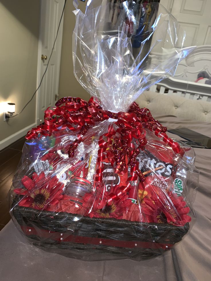 a basket filled with candy and candies on top of a bed