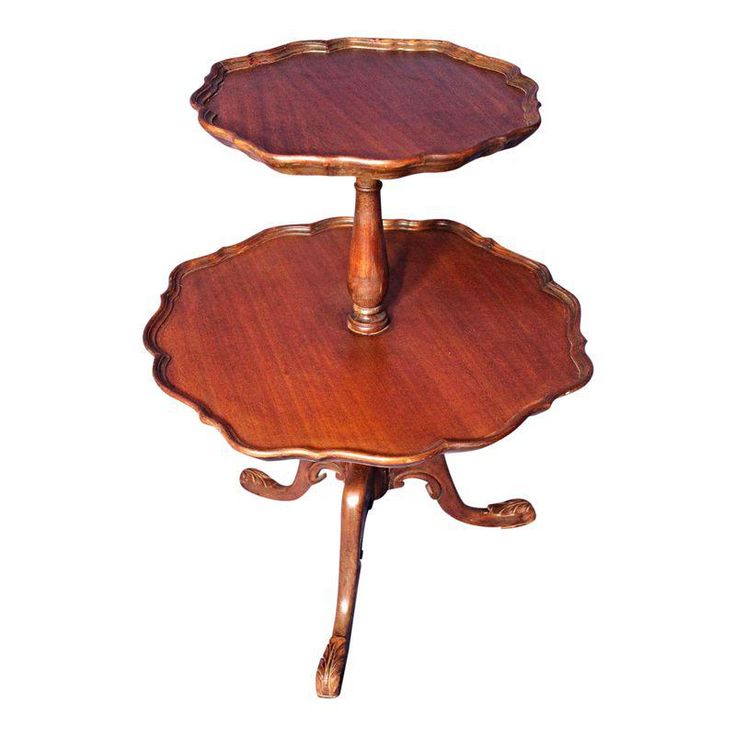 two tiered wooden tray with handles on each side and an ornate design at the top