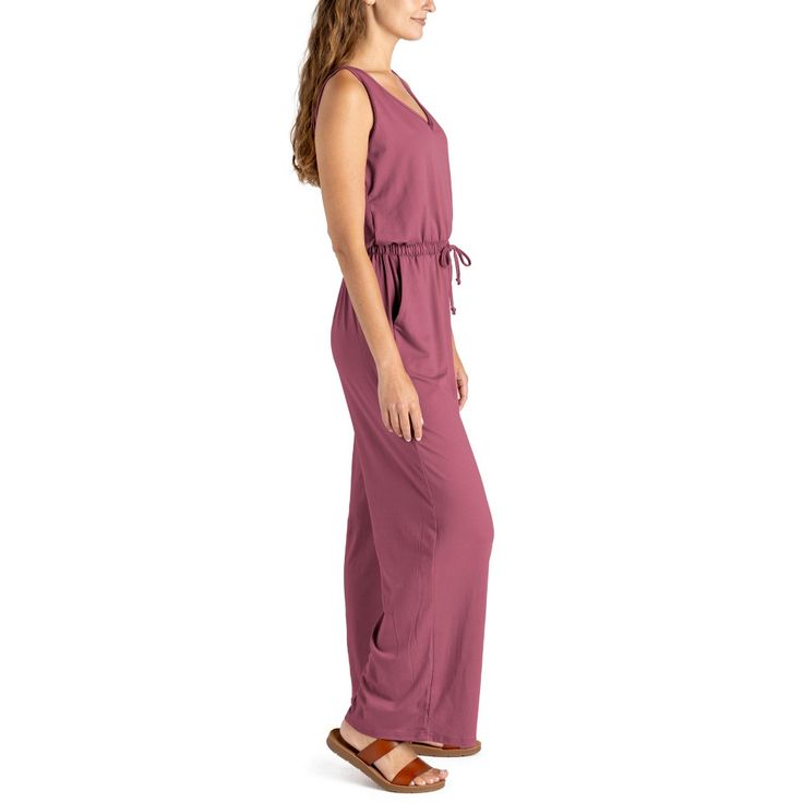 Made from super soft, lightweight stretchy fabric, this jumpsuit is designed to be worn for any season or occasion, making it a staple in your wardrobe. The flattering relaxed fit and wide-leg style with side pockets add a touch of casual sophistication, while the open V-neck and elastic waistband with a drawstring tie create a flattering silhouette that complements any body type. Dress it down with your favorite sandals for a laid-back daytime look or dress it up with wedges and sparkling state Spring Solid Jumpsuits And Rompers With Side Pockets, Spring Solid Color Jumpsuits And Rompers With Side Pockets, Solid Color Jumpsuits And Rompers For Summer Lounging, Solid Jumpsuits And Rompers For Summer Lounging, Solid Jumpsuits And Rompers With Side Pockets For Spring, Beach Jumpsuits And Rompers With Elastic Waistband, Solid Jumpsuits And Rompers With Tie Waist For Loungewear, Solid Color Loungewear Jumpsuit With Tie Waist, Spring Comfortable Relaxed Fit Jumpsuits And Rompers