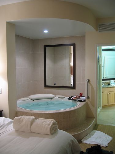 a large jacuzzi tub in the middle of a bedroom