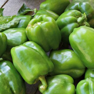 green peppers are piled on top of each other