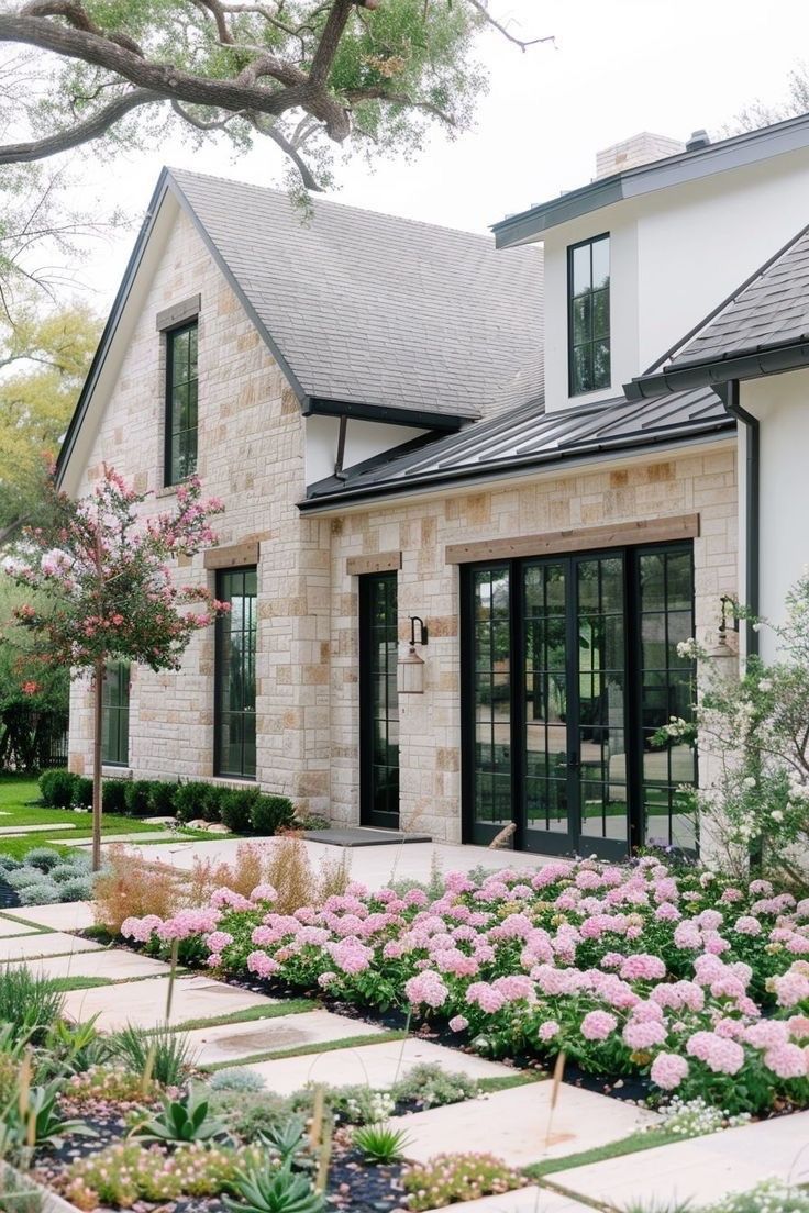 a house that has some flowers in front of it