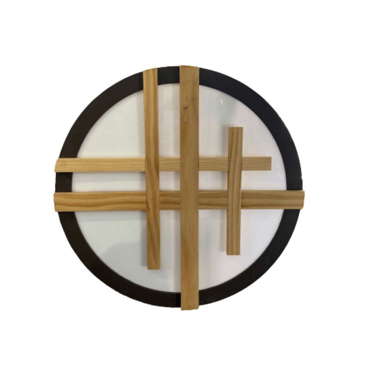 the cross is made out of wood and black circles with white paint on each side