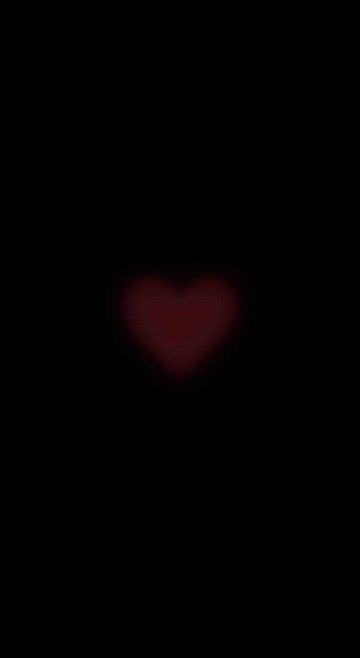 a blurry image of a red heart in the dark