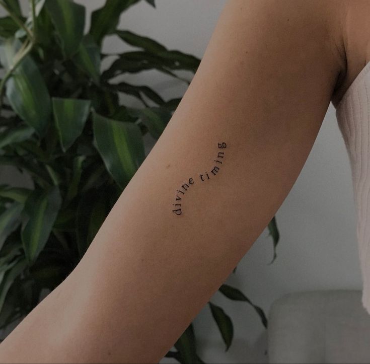 a woman with a tattoo on her arm that reads, we are the future is here