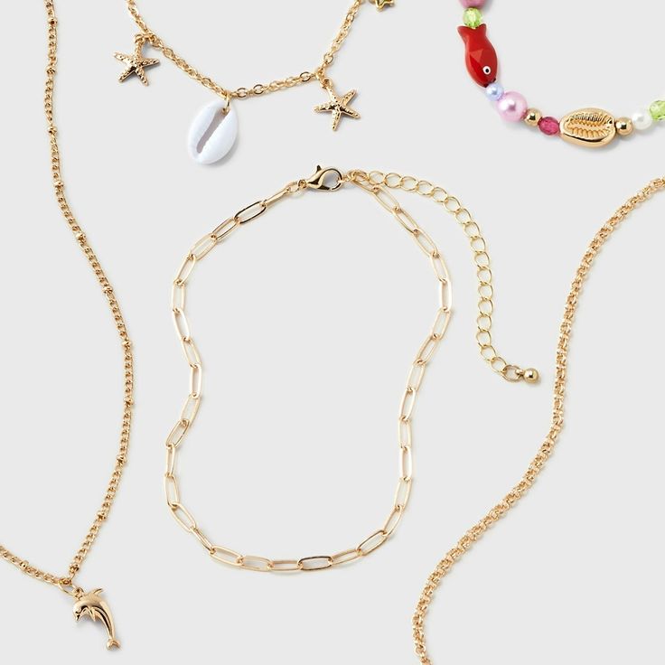 Welcome Summer and beachy vibes with this Girls' 5pk Mixed Necklace Set with Sea Life Charms from art class™. The assortment of gold chains features seashell motifs. The lobster claw clasp ensures a secure fit, while the pull-on design and 3-inch extender provide convenience and adjustability. Perfect for adding coastal charm to any outfit, these mixed necklaces set with sea life charms from art class captures the essence of summer. Art Class™: One-of-a-kind looks for the one and only you Ocean-inspired Charm Necklace For Summer Beach, Summer Beach Ocean-inspired Charm Necklaces, Summer Beach Ocean-inspired Charm Necklace, Ocean-inspired Summer Beach Charm Necklace, Ocean-inspired Gold Charm Necklaces For Summer, Gold Ocean-inspired Charm Necklaces For Summer, Gold Charm Necklaces For Summer Beach, Casual Gold Jewelry For Vacation, Summer Beach Charm Necklaces