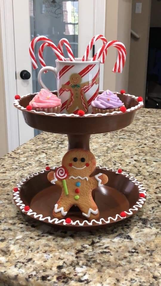 three tiered trays filled with cupcakes, candy canes and cookies