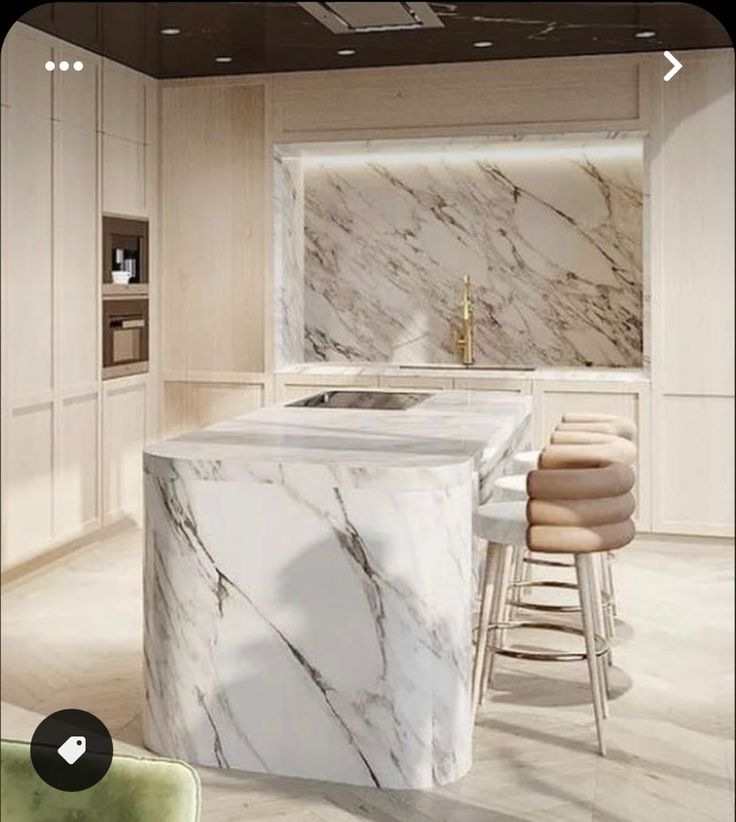 a kitchen with marble counter tops and stools next to a bar in the middle