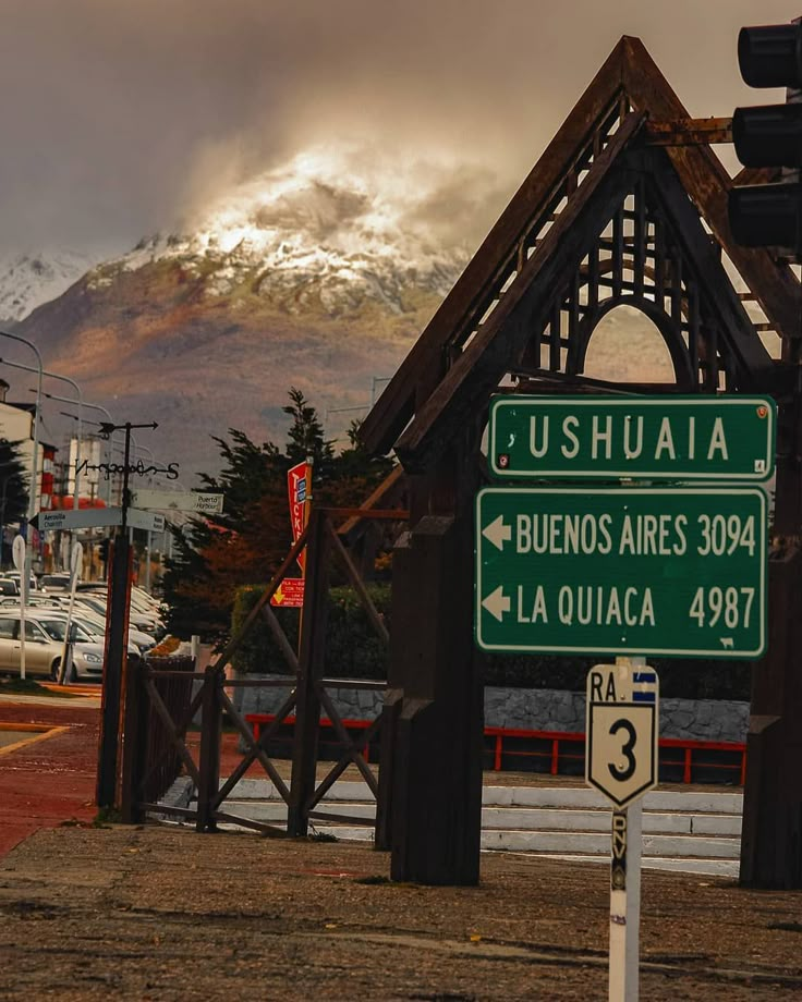 a street sign with mountains in the background