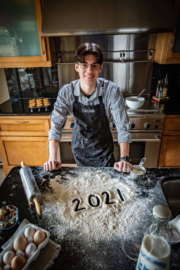 a man standing in front of a kitchen counter with flour on it and eggs around him